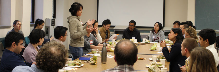 Vida Ahyong talking to people seated around a table