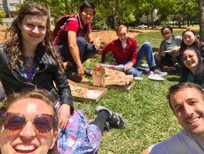 Megan Korber and friends enjoying pizza lunch on lawn at UC Berkeley
