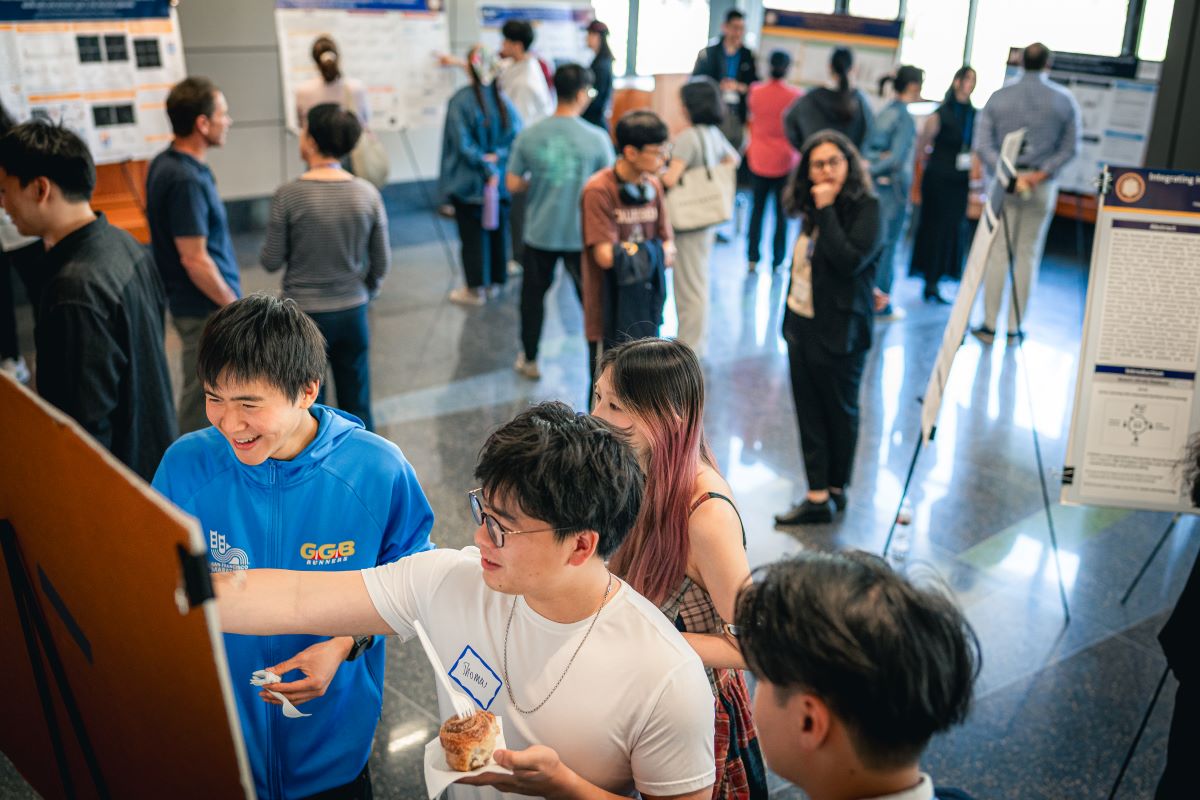 MBT students presenting their research through posters at the capstone symposium on May 16, 2025